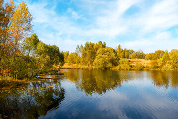 Autumn trees reflected in water
