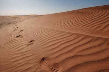 Sunset over the sand dunes in the desert.