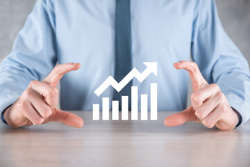Businessman man holding a graph with positive profits growth. plan graph growth and increase of...