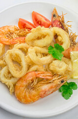 Fried calamari and shrimps on white plate