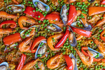 Spanish seafood paella in fry pan with mussels, shrimps and vegetables