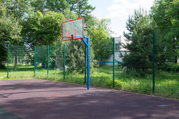 Basketball hoop on the playground. Sports ground in the courtyard of the house.