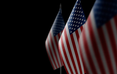 Small national flags of the United States on a black background