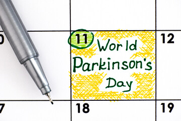 Reminder World Parkinson's Day in calendar with pen.