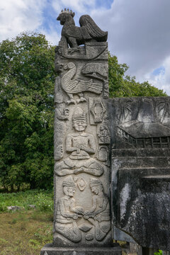 Beautiful traditional megalithic grave headstone carved with rooster, bird, crocodile and men in Pau Rende village, Sumba island, East Nusa Tenggara, Indonesia