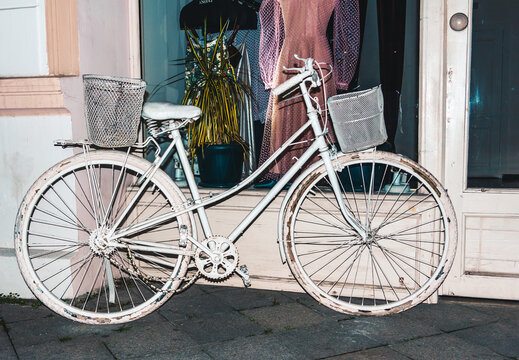 Old bike near the store to attract customers. Minimalistic creative concept for creative ideas.