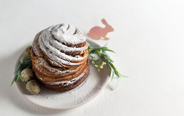 Homemade Easter orthodox sweet bread  Kulich-Cruffin on a light background. Paska. Bright Easter holiday. Flaky dough of croissant meets moist muffin meets flavorful Kulich. Horizontal orientation.