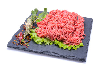 Fresh minced pork and beef and spices on a slate stone.Isolated on a white background, selective focus. horizontal view.