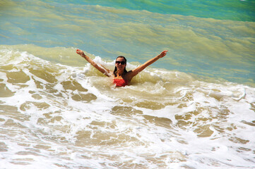 Young woman having fun in stormy sea