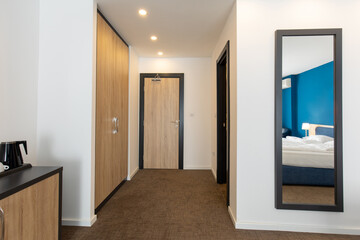 Hotel room entrance corridor with wooden closet