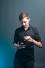 A young man holds a bottle of whiskey