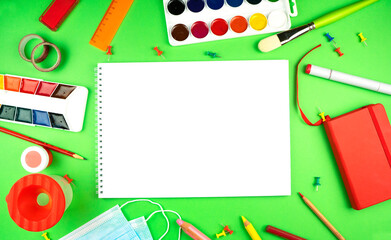Colorful back to school education flat lay banner with a blank space for your text. Watercolor, brush, equipment for writing.