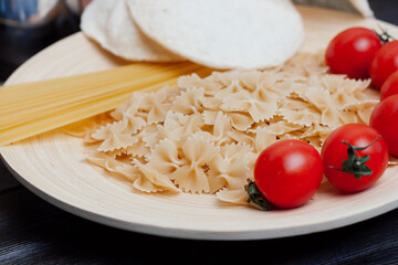 Italian pasta kitchen cooking wood table ingredients cherry tomatoes
