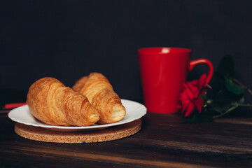 crispy croissants on a plate wooden table coffee mug