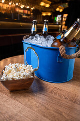 beer in ice bucket in dark tones