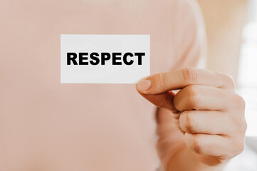 Man holding a business card with RESPECT