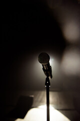 Close up of microphone on stage in black background