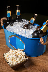 beer in ice bucket in dark tones