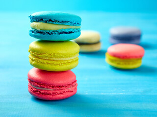 Sweet Macaron of different colors on an azure background