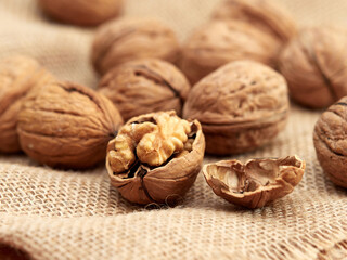 Close-up walnuts lie on a burlap.