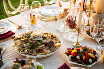 Served outdoor banquet table with assorted oriental appetizers