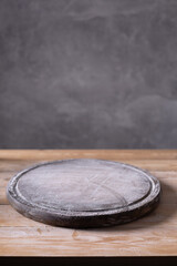 Pizza or bread cutting board and scattered wheat flour powder for homemade baking on wooden table