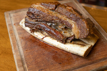 close-up juicy grilled beef rib on wooden chopping board