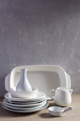Empty crockery or ceramic dishes set. White kitchen dishware and tableware wood table
