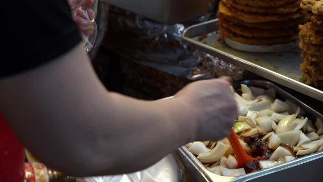 Sliced Onion with Soy Sauce, Side dish of Korean traditional mung bean pancake, Street food in Korean market.