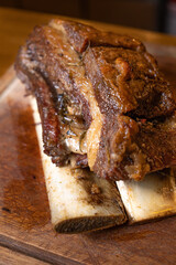 close-up juicy grilled beef rib on wooden chopping board