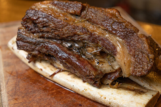close-up juicy grilled beef rib on wooden chopping board