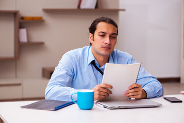 Young male employee working from home during pandemic