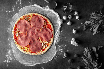 Prepared dough base for cooking pizza with ham and cheese