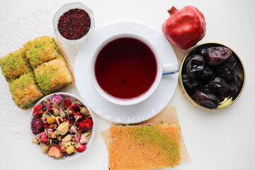 oriental sweets. traditional Turkish baklava with pistachios and pomegranate tea