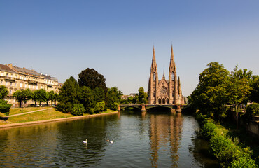 Fototapeta na wymiar A nice view on The St. Paul's Church of Strasbourg, France. It is located on the point where the Ill and Aare rivers join. Beautiful sunny summer day.
