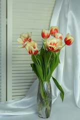 A bouquet of flowers in a vase. Yellow-red tulips.