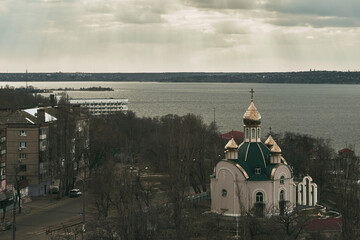 astern Orthodox Church on the river. Sky moving with god rays. Skylapse of the church with golden domes. Dome of the church reflecting floating sky