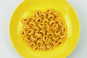 Plate of handmade tortellini ready for cooking, traditional cuisine, italy 