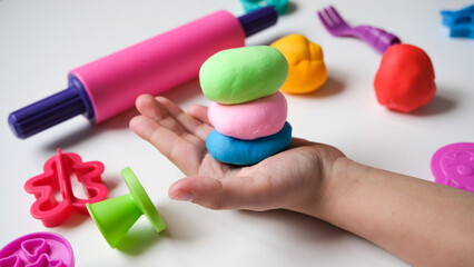 Children's hands play with plastic multi-colored mass. Modeling and development of fine motor...