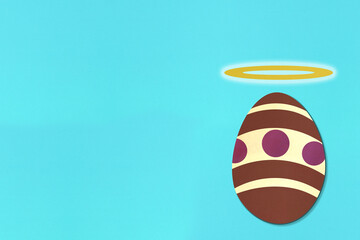 Easter egg with halo on light blue background. Colorful. Paper texture. Illustration.