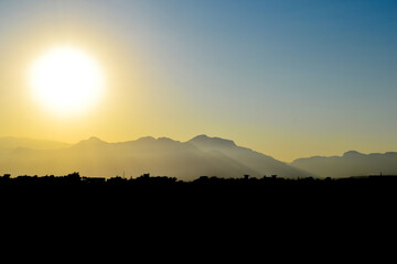 silhouette of the city under the harsh sun