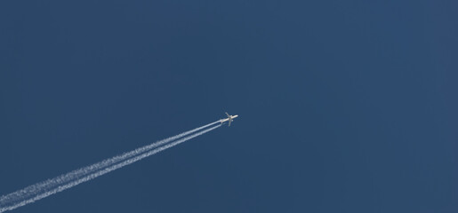 aeroplane with vapour trails in the sky