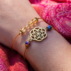 Seed of life brass pendant bracelet with citrine mineral beads bracelet on female hand