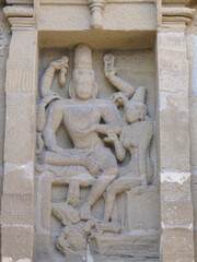 Selective focus Close up image of ancient sculptures carved on stone of Hindu God and Goddess on a temple wall
