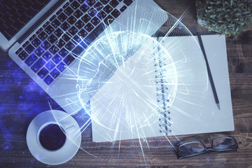 Business theme hologram drawings over computer on the desktop background. Top view. Multi exposure. Concept of international connections.