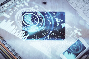 Double exposure of business theme hologram over desktop with phone. Top view. Mobile international...