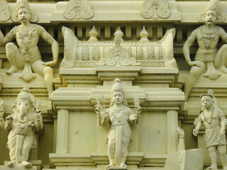 Selective focus Close up image of ancient sculptures carved on stone of Hindu God and Goddess on a temple wall
