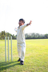 Fototapeta na wymiar Young boy bowling leg spin in a cricket