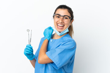 Young woman dentist holding tools isolated on white background celebrating a victory