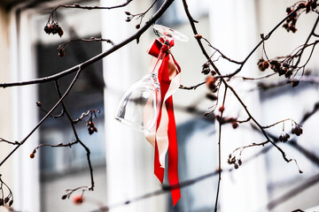 Wine Glass hung on a branch with colorfull ribbons celebrating early Easter season